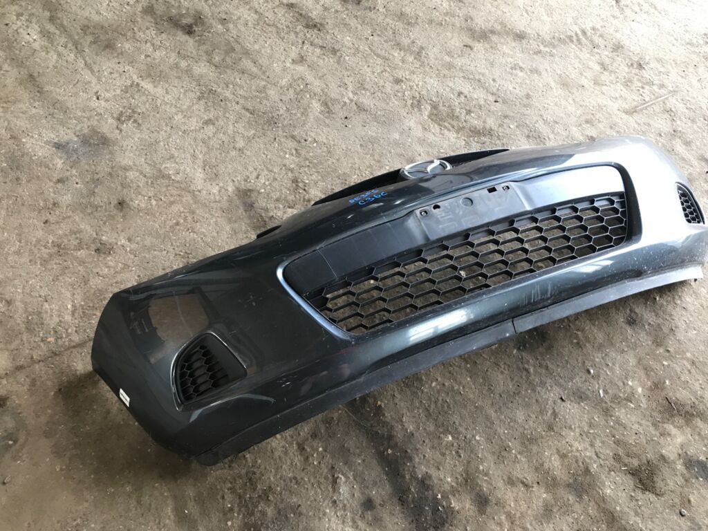 Бампер на Mazda Demio DE3FS 038D65150031C8N  25301967  2741570  3421901  5605050  931104  D65150031B8H  D65150031BAA  D65150031C8N  D65150031CAA  D65150031CBB  MZ04105BA  MZ04105BAV  MZ04105BB  MZ51100000000  STMZ520000, Переднее расположение
