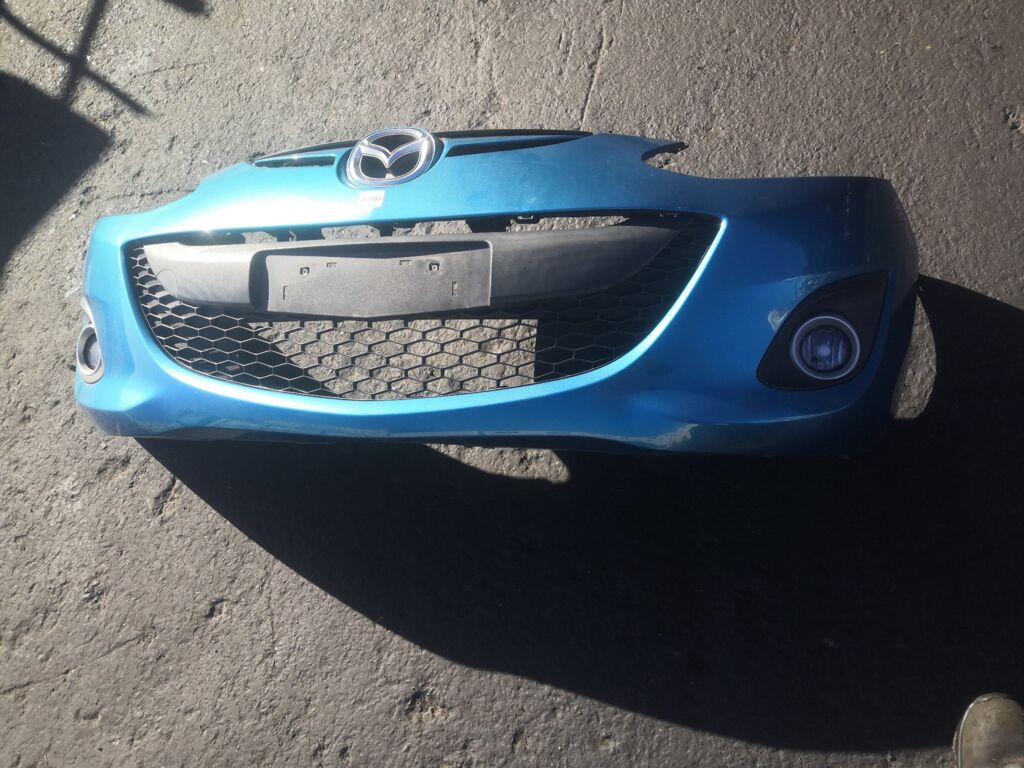 Бампер на Mazda Demio DEJFS 114-61010 DR61-501T1, Переднее расположение